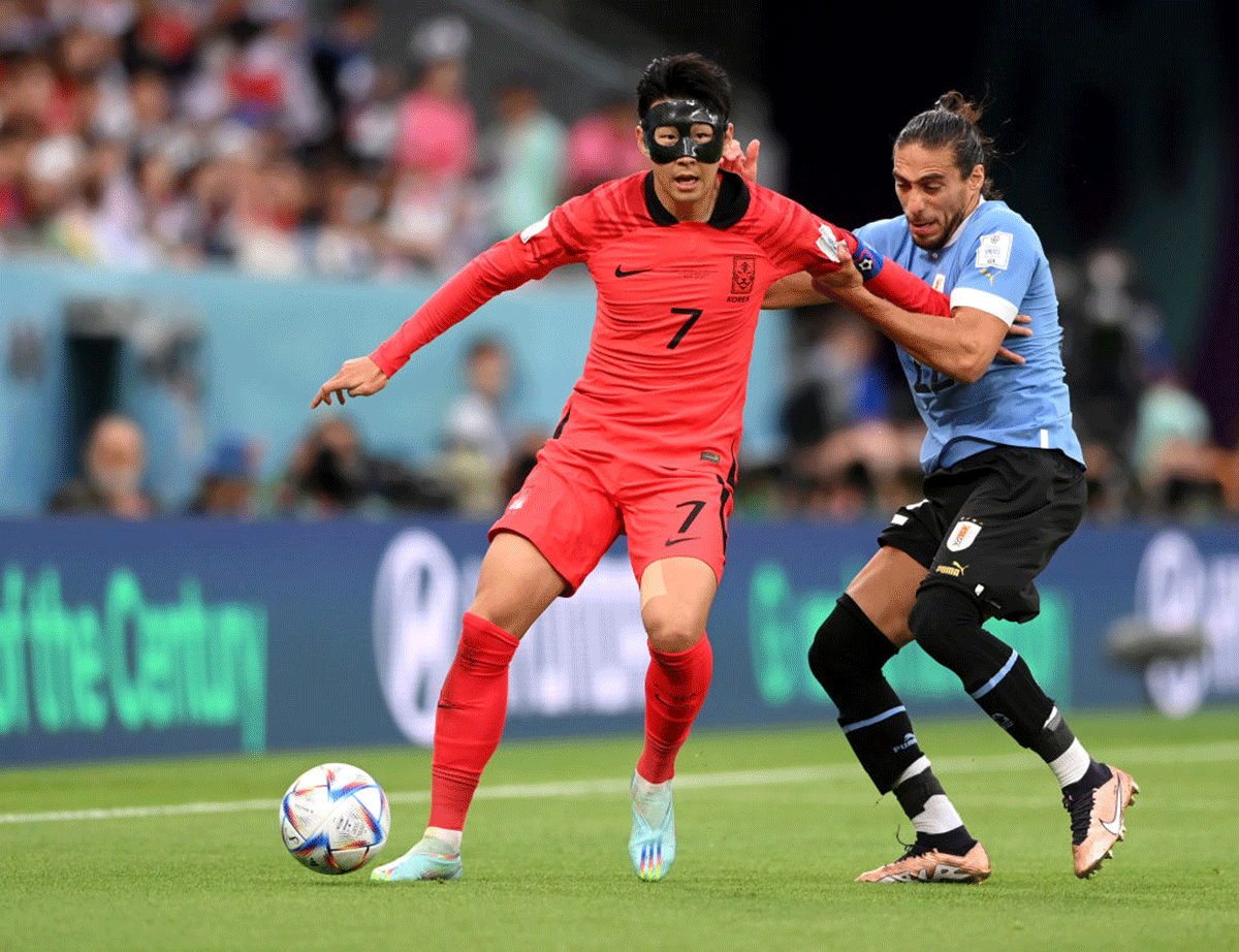 South Korea's Heung-min Son is challenged by Uruguay's Darwin Nunez.