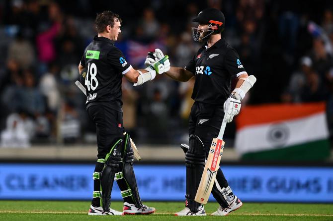 Tom Latham is congratulated by skipper Kane Williamson after completing his hundred.