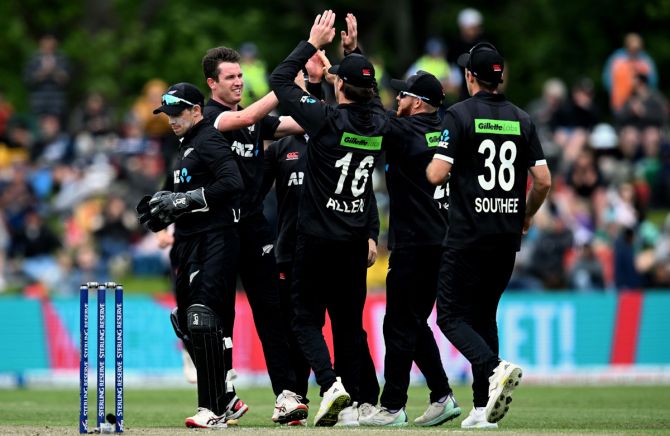 Adam Milne celebrates with his New Zealand teammates after dismissing Shubman Gill.
