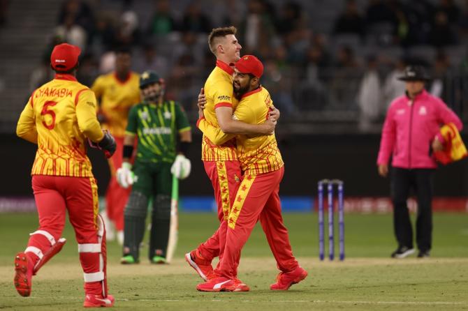 Bradley Evans and Sikandar Raza celebrate the wicket of Babar Azam