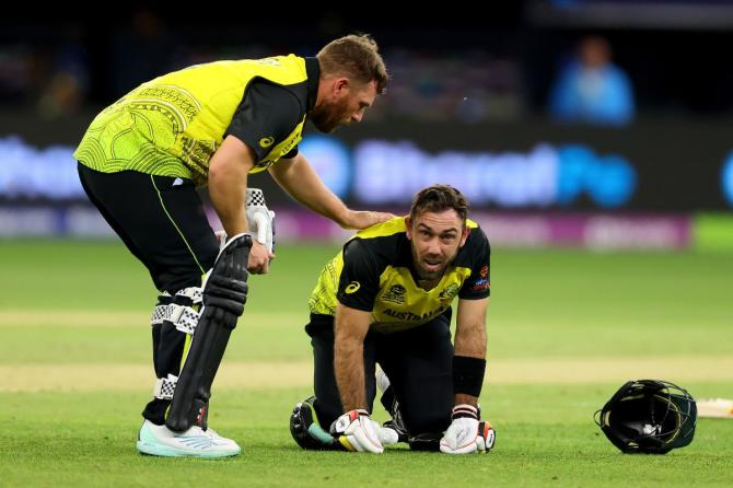 Glen Maxwell of Australia reacts after getting hit by the ball as Aaron Finch of Australia checks on him