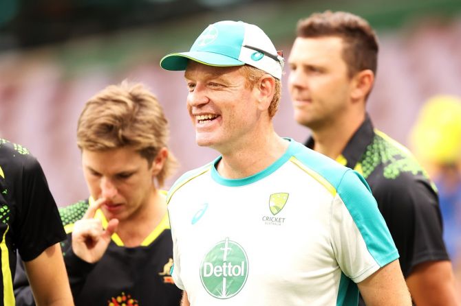 Australia coach Andrew McDonald shares a light moment with his players during a nets session.