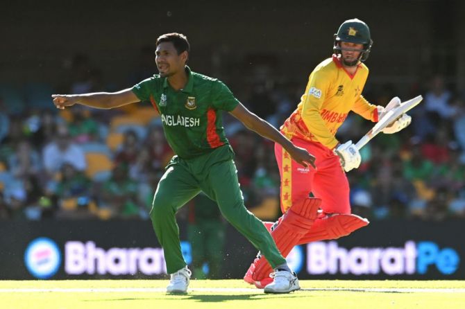 Mustafizur Rahman of Bangladesh gestures as Sean Williams of Zimbabwe runs between the wickets 