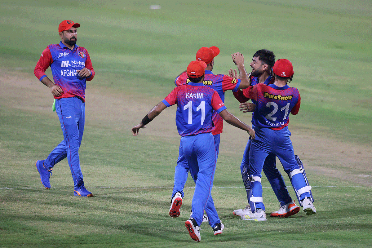 Rashid Khan celebrates with teammates after dismissing Shadab Khan