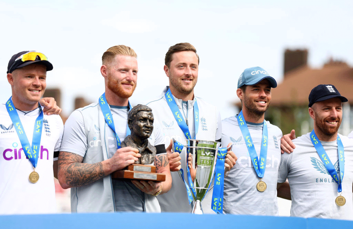 England captain Ben Stokes (2nd from left) Ollie Robinson and his team celebrate behind the winners board after their 2-1 series victory