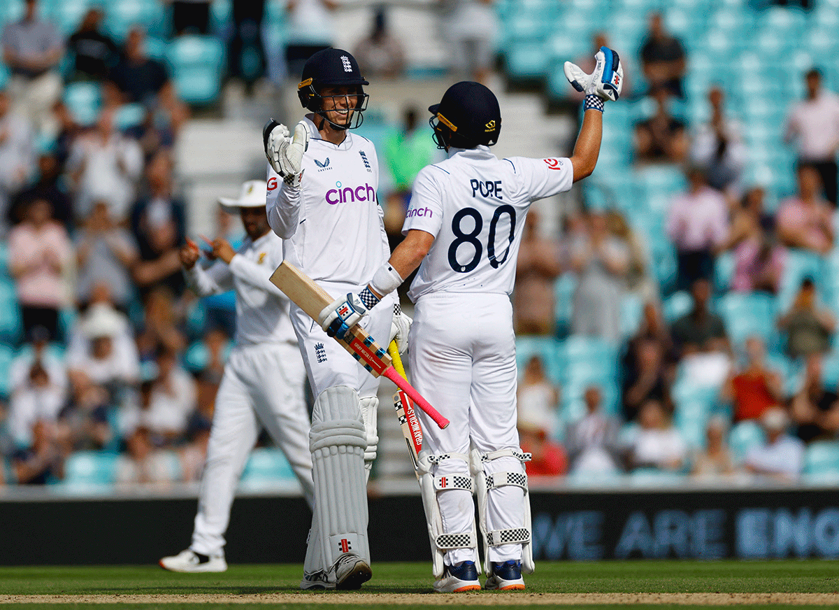 England's Ollie Pope and Zak Crawley celebrate winning the match and series against South Africa at the Oval in London on Monday