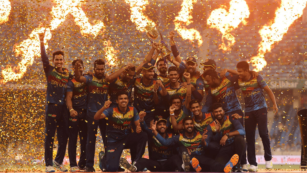 Sri Lanka players celebrate with the trophy after defeating Pakistan to win the Asia Cup title on Sunday