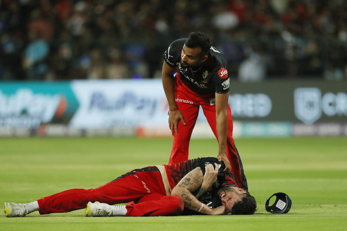 RCB pacer Reece Topley is sidelined after dislocating his right shoulder while fielding during the match against Mumbai Indians in Bengaluru on Sunday.	