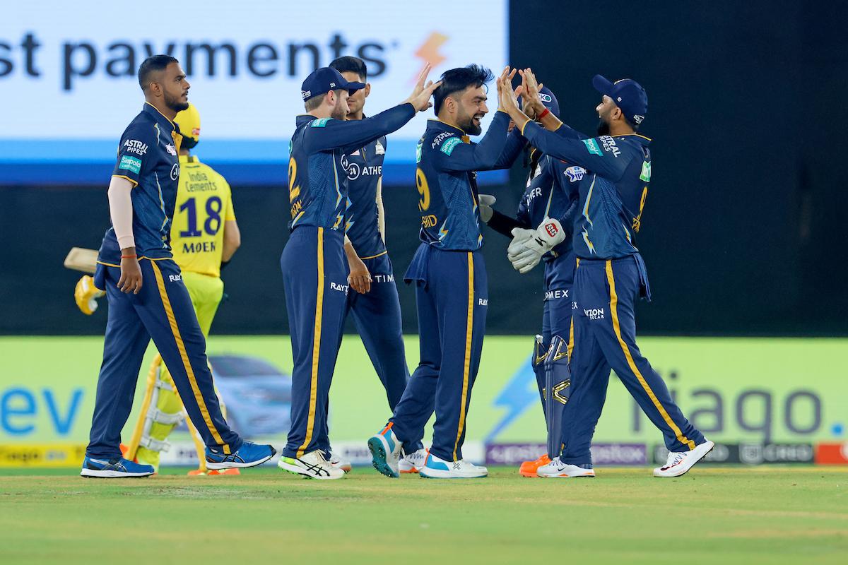 Rashid Khan is congratulated by his Gujarat Titans teammates after dismissing Moeen Ali during the IPL match against Chennai Super Kings at Narendra Modi Stadium in Ahmedabad.