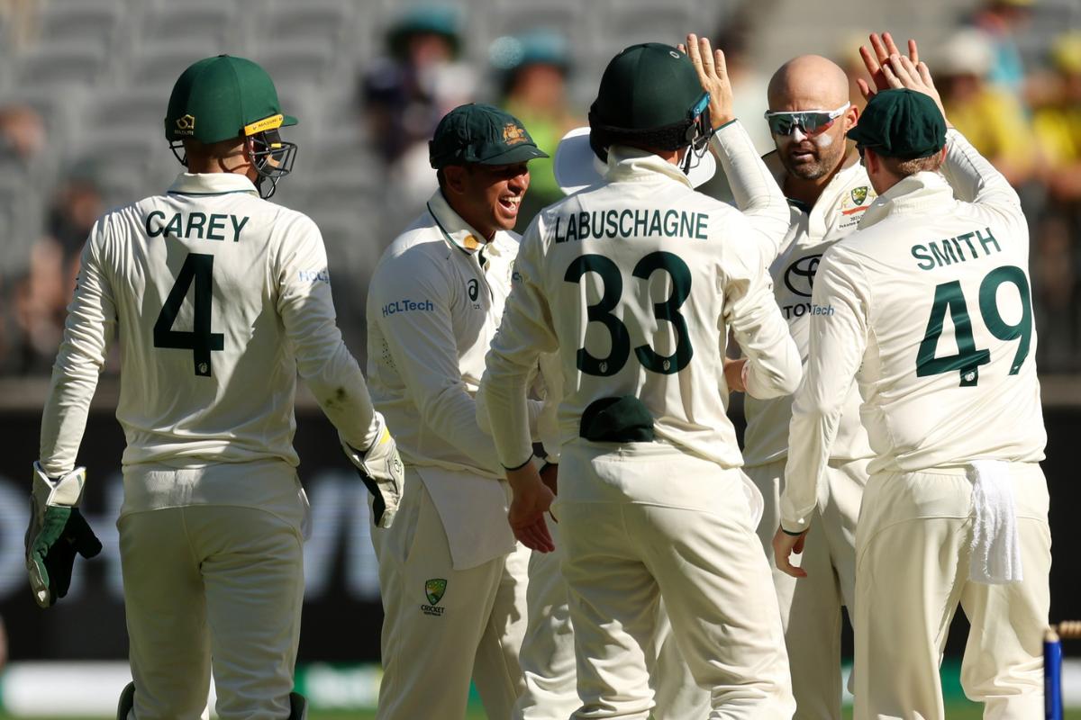 Australian spinner Nathan Lyon celebrates with teammates after dismissing Pakistani opener Abdullah Shafique