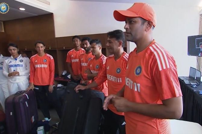 Coach Amol Muzumdar speaks to his players in the dressing room after their emphatic win in the one-off Test against England in Navi Mumbai