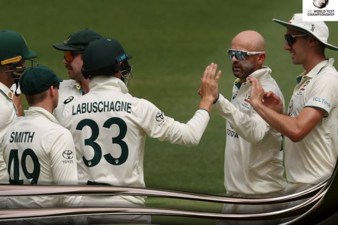Nathan Lyon celebrates with teammates after dismissing Khurram Shahzad for his 489th Test wicket