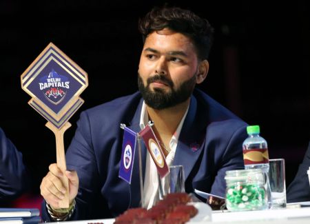 Delhi Capitals Captain Rishabh Pant -- the first active player at an IPL players auction -- holds up the paddle to make a bid during the IPL 2024 auction in Dubai on Tuesday, December 19, 2023