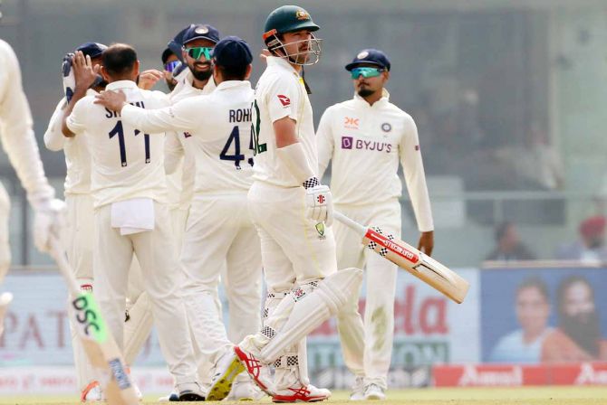 India's players celebrate as Travis Head walks back after being dismissed by Mohammed Shami.