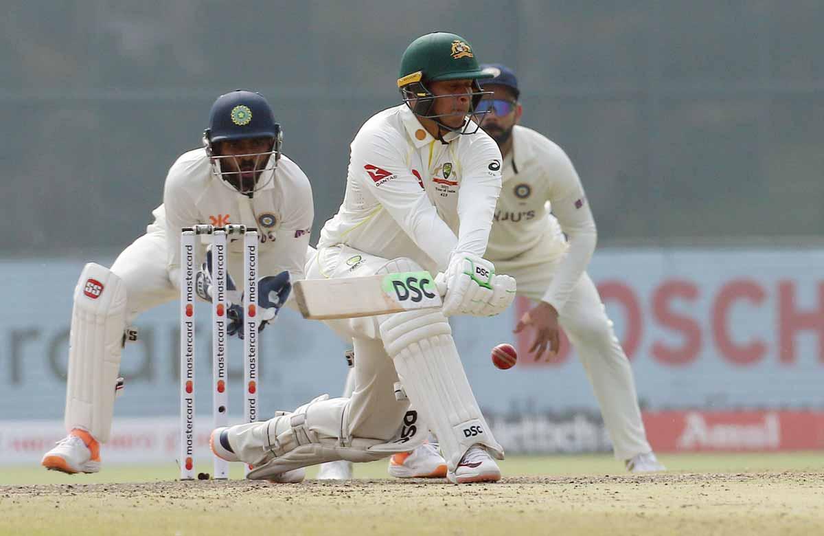 Usman Khawaja plays the reverse sweep.