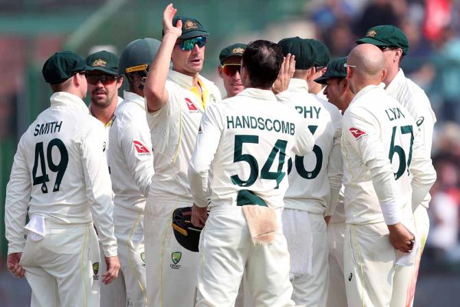 Nathan Lyon celebrates with teammates after dismissing Cheteshwar Pujara.