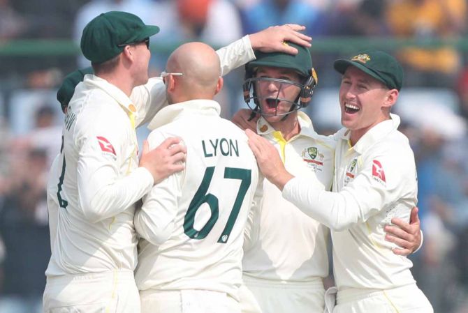  Australia's players celebrate the wicket of KL Rahul in India's second innings.