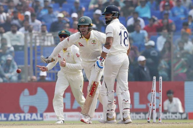 Wicketkeeper Alex Carey celebrates after stumping Virat Kohli off the bowling of Todd Murphy.