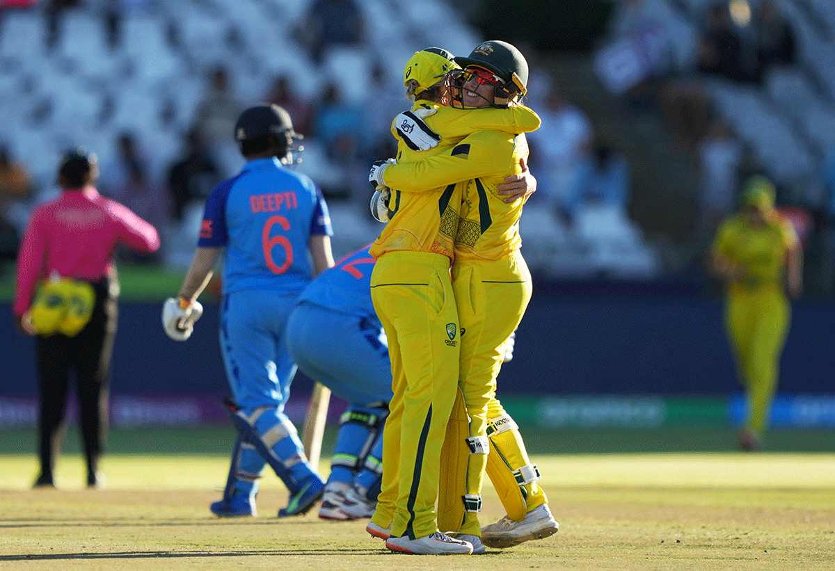 Australia's Beth Mooney celebrates with Alyssa Healy after beating India to win the Women's T20 World Cup semi-final in Cape Town on Thursday