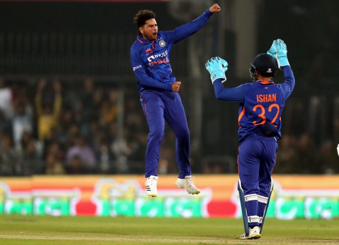 Kuldeep Yadav celebrates after taking the wicket of Henry Nicholls.