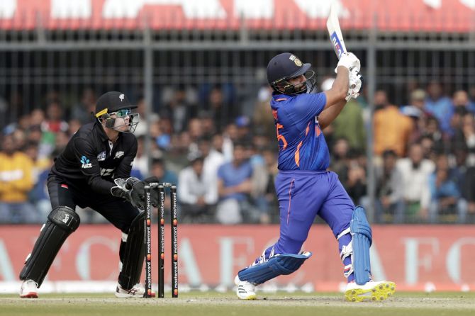 Rohit Sharma goes over the top during his innings of 101