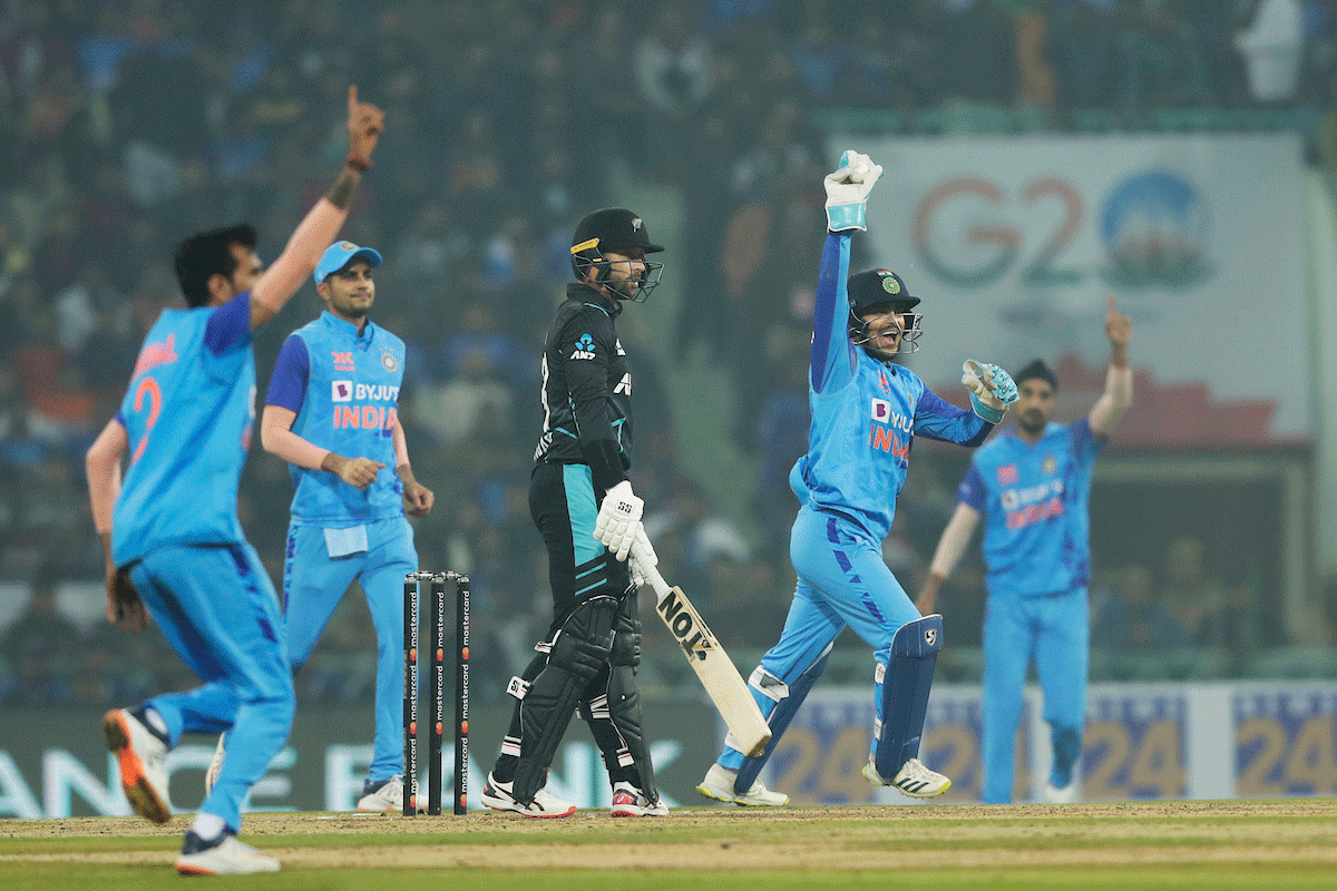 Wicketkeeper Ishan Kishan celebrates taking the catch to dismiss Devon Conway.