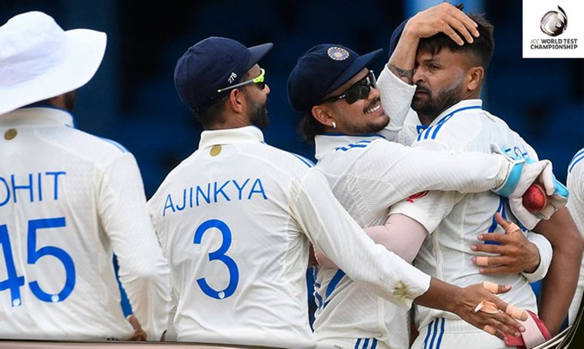 Mukesh Kumar celebrates with his India teammates after dismissing debutant Kirk McKenzie for his maiden Test wicket.