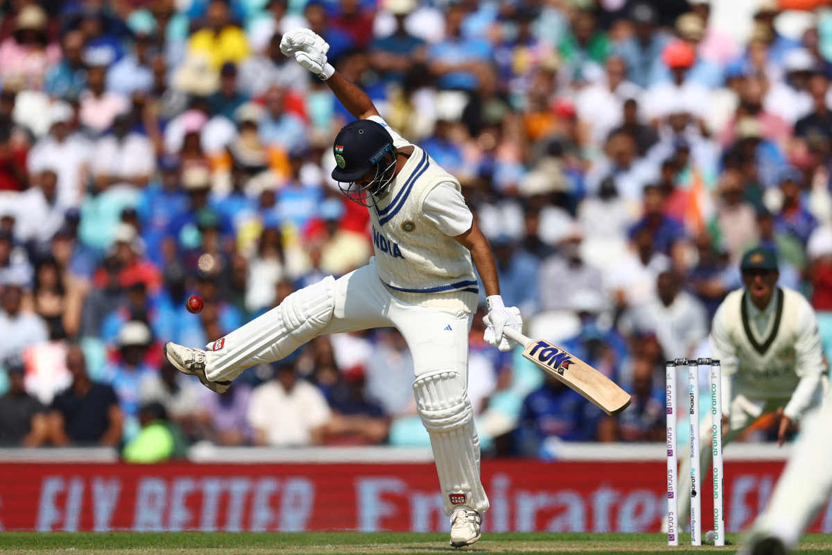 India's Shardul Thakur reacts after being hit on the forearm