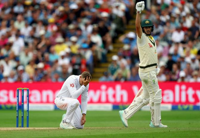 Joe Root reacts after missing a catch off Pat Cummins