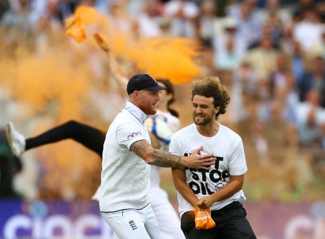 Ben Stokes tries to stop a protester