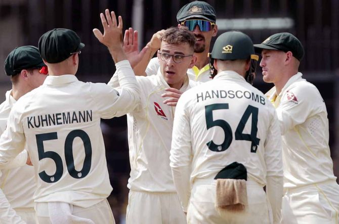 Todd Murphy celebrates with his team-mates after taking the wicket of Virat Kohli