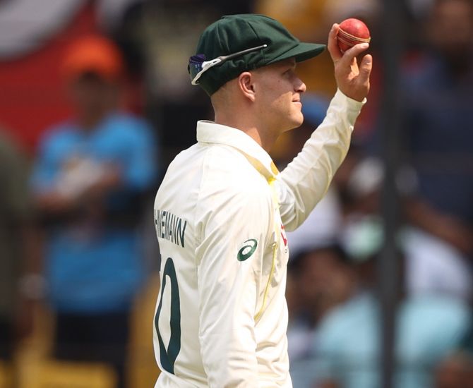 Australia's Matthew Kuhnemann holds up the ball after taking five wickets in the first innings of the third Test