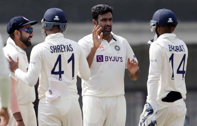 Ravichandran Ashwin celebrates with team-mates after taking the wicket of Alex Carey.