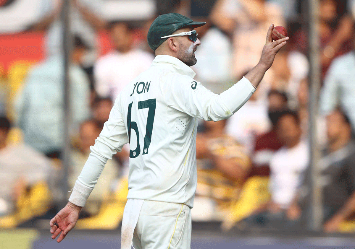 Nathan Lyon walks off with the ball after finishing with 8 wickets