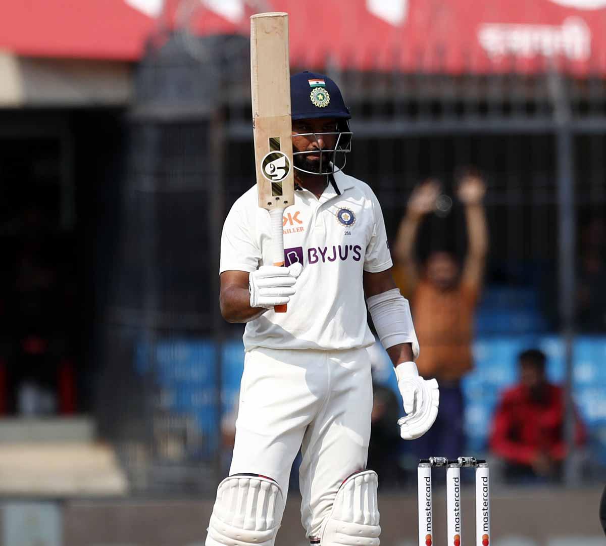 Cheteshwar Pujara celebrates after scoring a fifty.