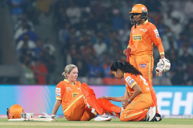 Gujarat Giants’ skipper Beth Mooney receives attention from the physio after injuring her knee during the first over of their innings in the tournament opener against Mumbai Indians on Saturday