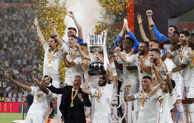Real Madrid's players celebrate with the trophy after victory over Osasuna in the Copa del Rey final at Estadio de La Cartuja, Seville, Spain, on Saturday.