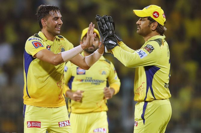Deepak Chahar celebrates with captain Mahendra Singh Dhoni after taking the wicket of Wriddhiman Saha.