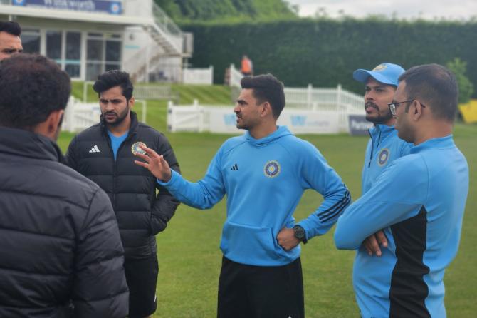 The players and support staff chat