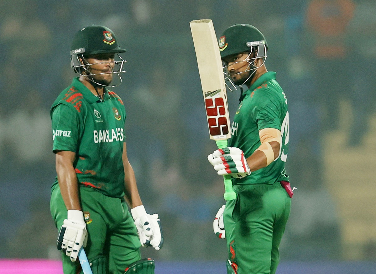 Najmul Hossain Shanto waves to the crowd as Shakib Al Hassan watches after scoring 50 during the ICC World Cup match in Delhi on Monday