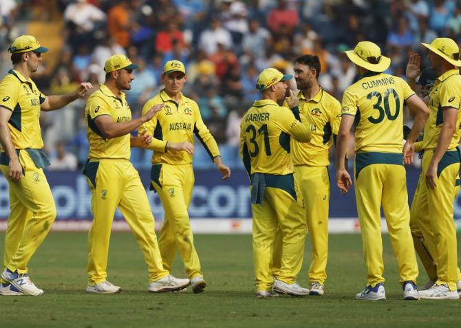 Glenn Maxwell celebrates with teammates after dismissing Rahmat Shah.