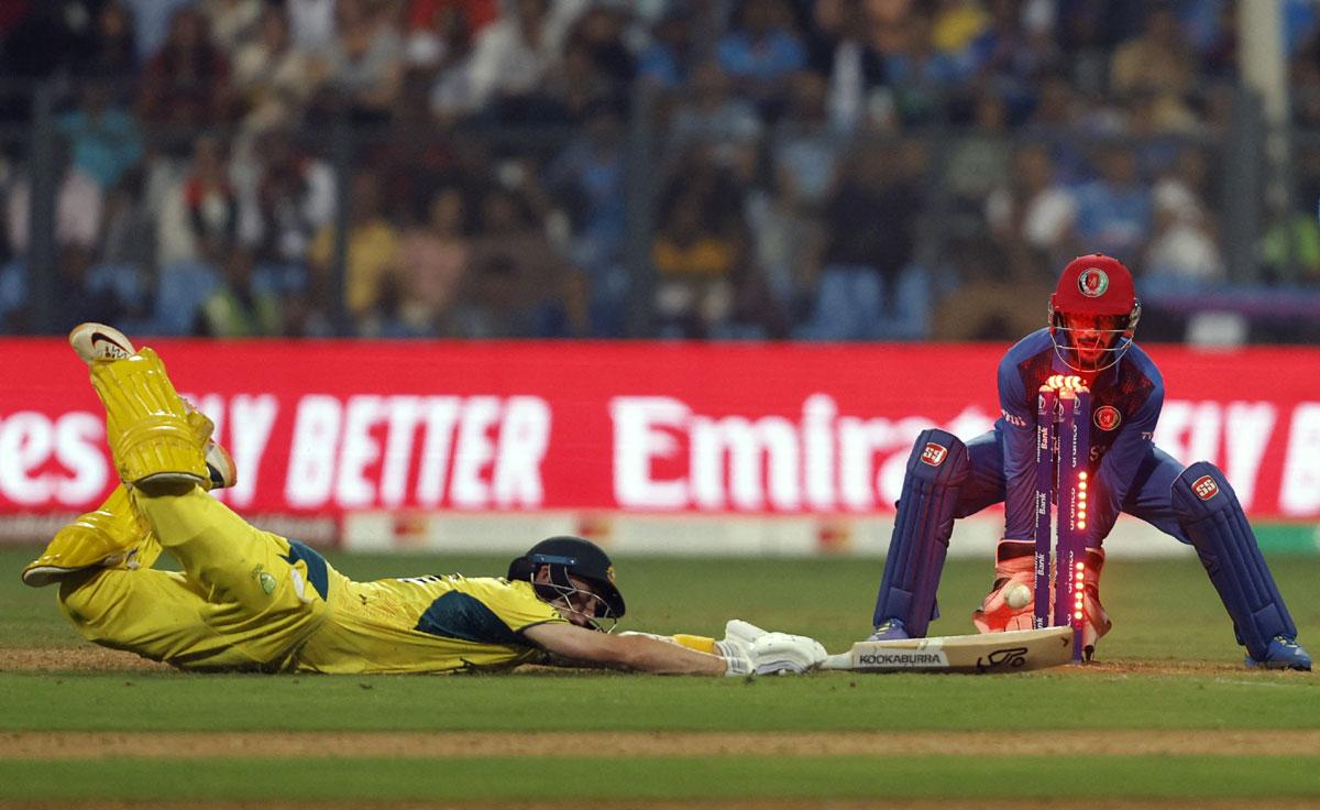 Marnus Labuschagne dives to make his ground but is beaten by the direct hit from Rahmat Shah