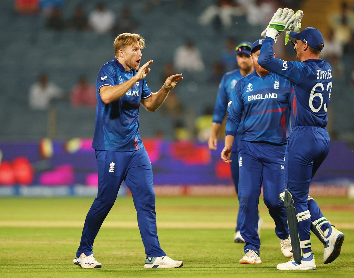 England pacer David Willey celebrates with teammates after having Colin Ackermann caught by Jos Buttler.