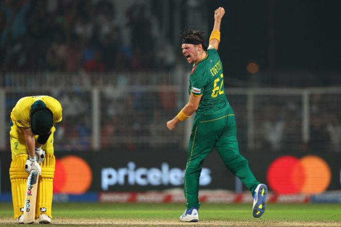 South Africa's Gerald Coetzee celebrates after taking the wicket of Australia's Steve Smith 