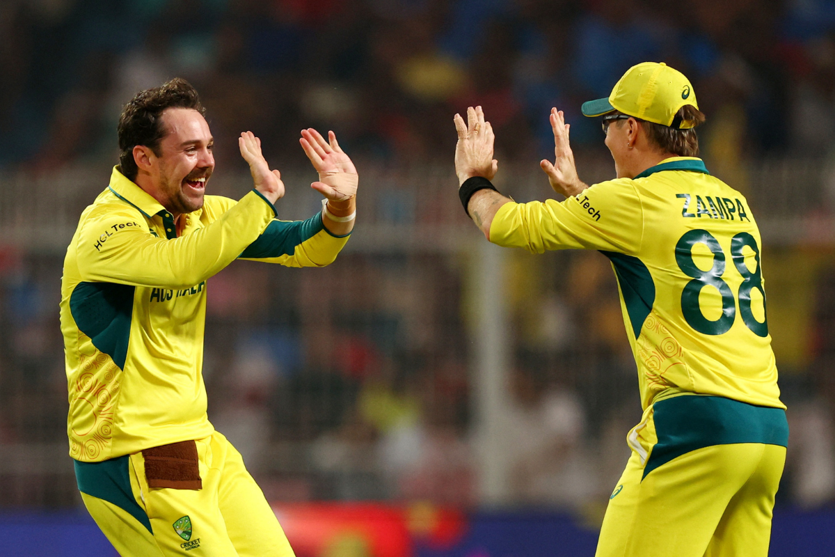Australia's Travis Head celebrates with Adam Zampa after taking the wicket of South Africa's Marco Jansen