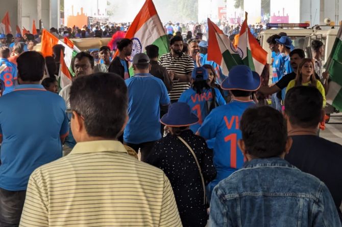 Flags in hand, fans heading towards the Narendra Modi Stadium for the ICC World Cup final between India and Australia in Ahmedabad on Sunday