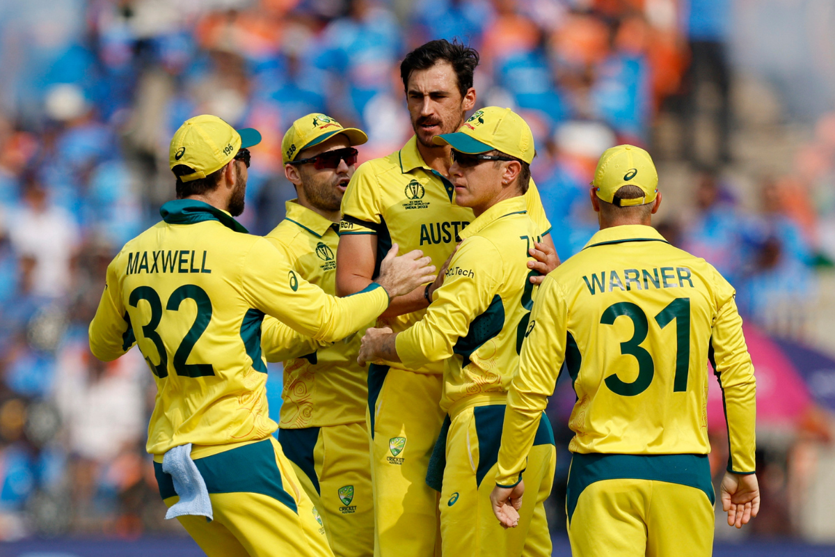 Australia's Mitchell Starc celebrates with teammates after taking the wicket of India's Shubman Gill, caught out by Adam Zampa