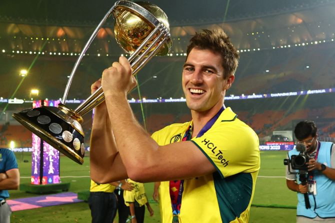 Australia's Pat Cummins celebrates with the trophy after winning the ICC Cricket World Cup on Sunday