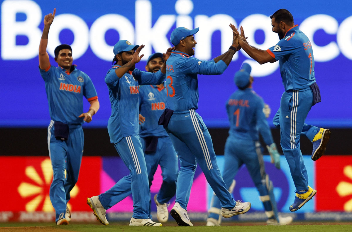 Mohammed Shami celebrates with teammates after taking the wicket of Sri Lanka's Dushan Hemantha at the Wankhede in Mumbai on Thursday