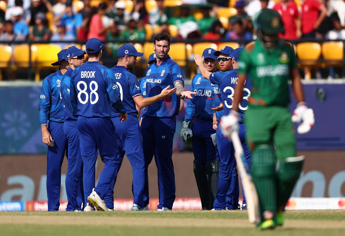 England's Reece Topley celebrates after taking the wicket of Bangladesh's Najmul Hossain Shanto, caught by Liam Livingstone